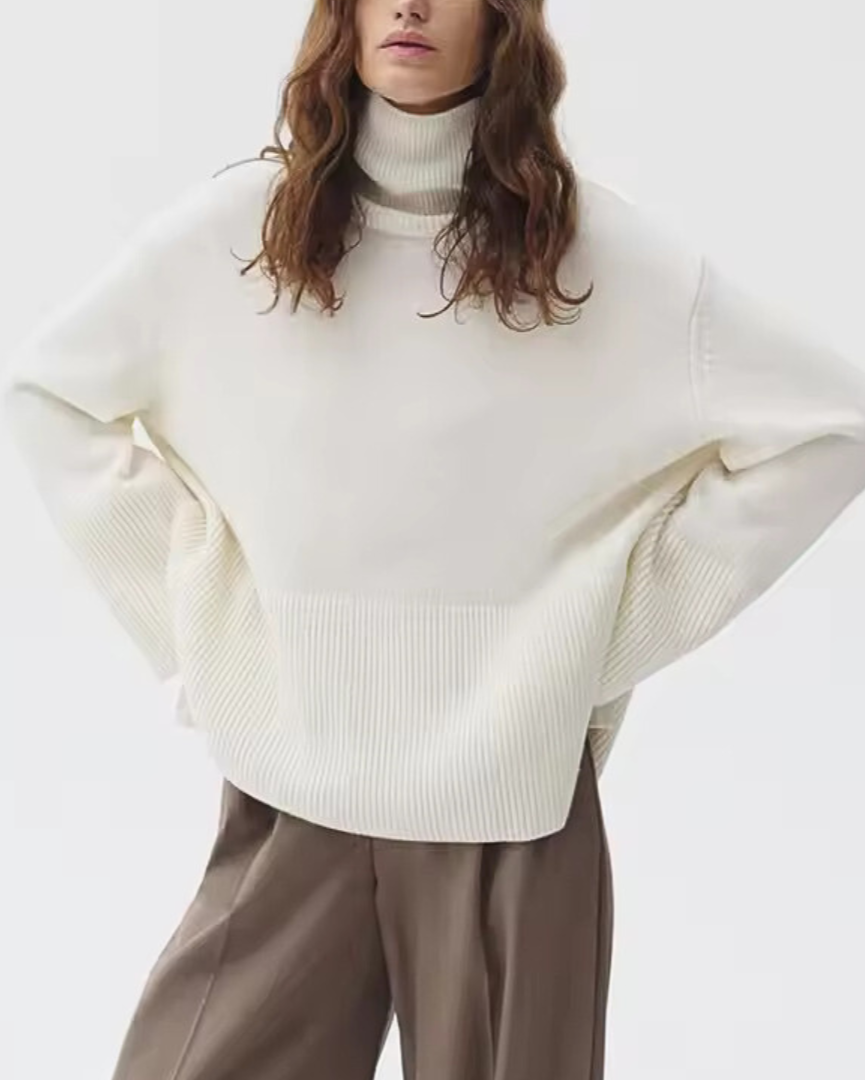 Ivory knit turtleneck sweater with long sleeves and ribbed cuffs