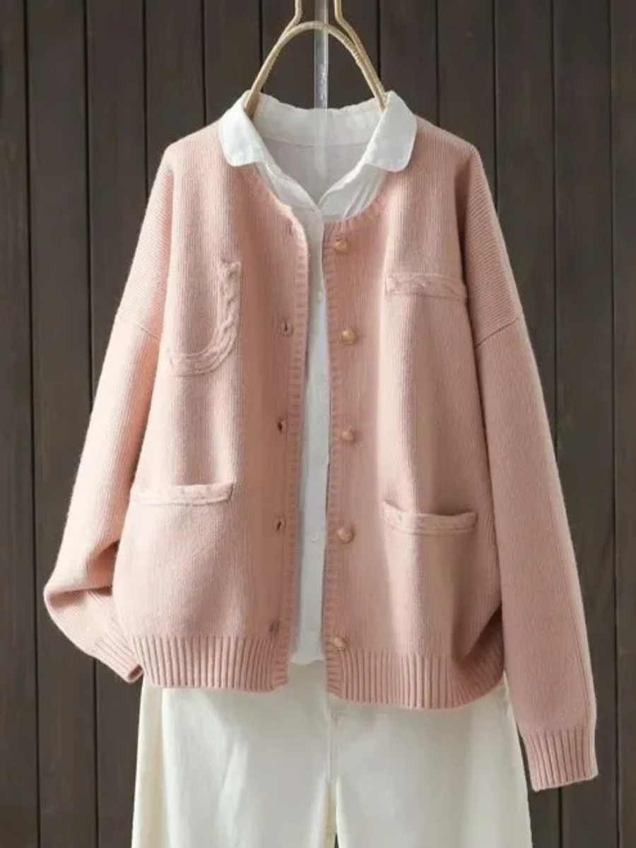 Light pink button-front cardigan sweater with stand collar, front pockets, ribbed cuffs