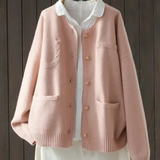 Light pink button-front cardigan sweater with stand collar, front pockets, ribbed cuffs