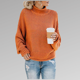 Orange chunky knit sweater with ribbed turtleneck, long sleeves, and straight hem