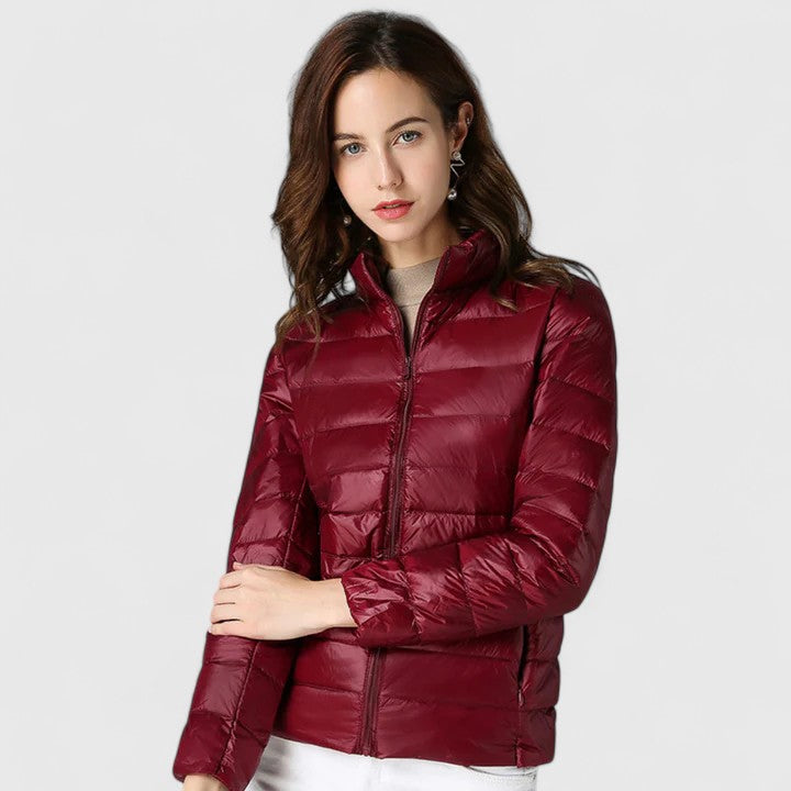 Burgundy quilted puffer jacket with zip front and stand collar, model posing