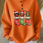 Orange vintage Christmas henley sweater with dog motif and festive stockings graphic