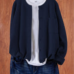 Navy blue round-neck cardigan with button front and side pocket