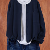 Navy blue round-neck cardigan with button front and side pocket