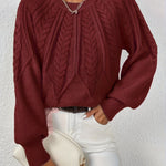 Burgundy cable-knit long-sleeve pullover with half-zip neckline and ribbed cuffs
