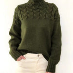 Women's cable-knit turtleneck sweater, dark green with raised front cable detail.