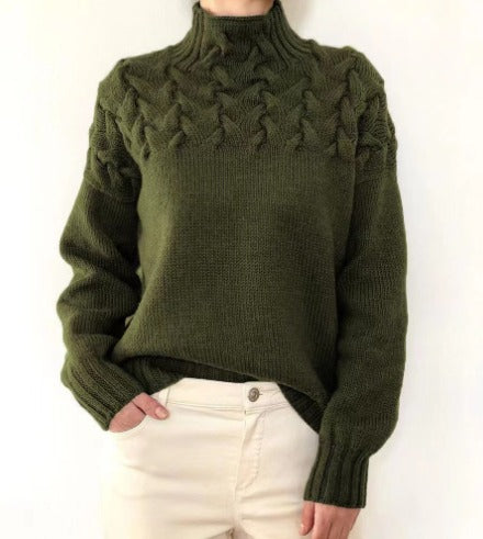 Women's cable-knit turtleneck sweater, dark green with raised front cable detail.