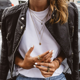Dark leather moto jacket with snap collar, zip pockets, and quilted shoulders