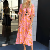 Orange patterned midi dress with V-neck button front and short sleeves
