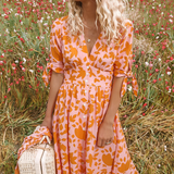 Orange patterned midi dress with V-neck buttons and gathered waist skirt