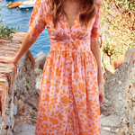 Orange patterned midi dress with V-neck and button-up bodice plus pleated skirt