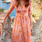 Orange patterned midi dress with V-neck and button-up bodice plus pleated skirt