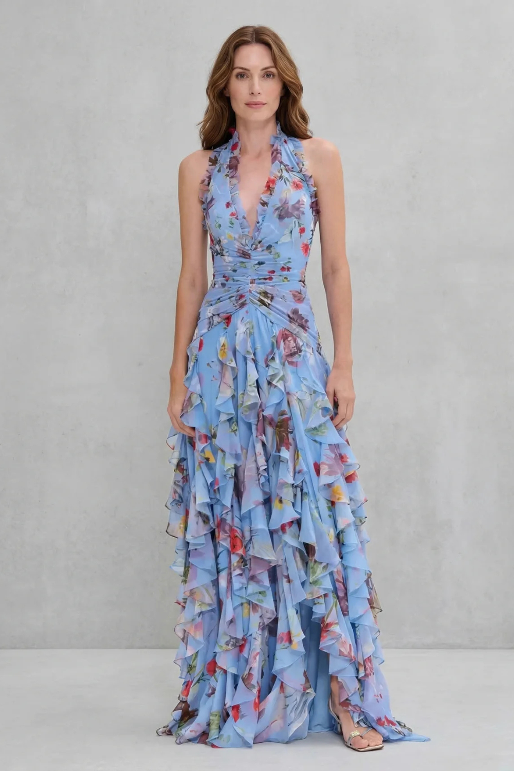 Blue floral halter maxi dress with braided tie waist detail and cascading ruffle tiers