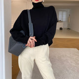 Black long-sleeve turtleneck knit pullover with ribbed collar