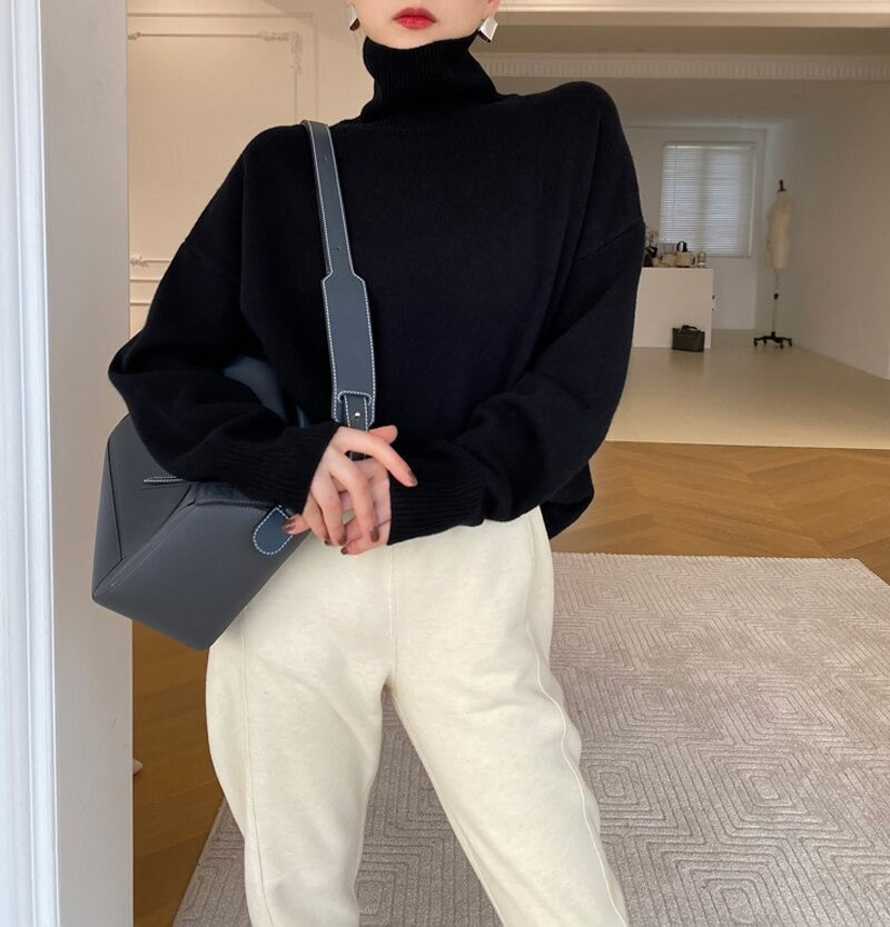 Black long-sleeve turtleneck knit pullover with ribbed collar