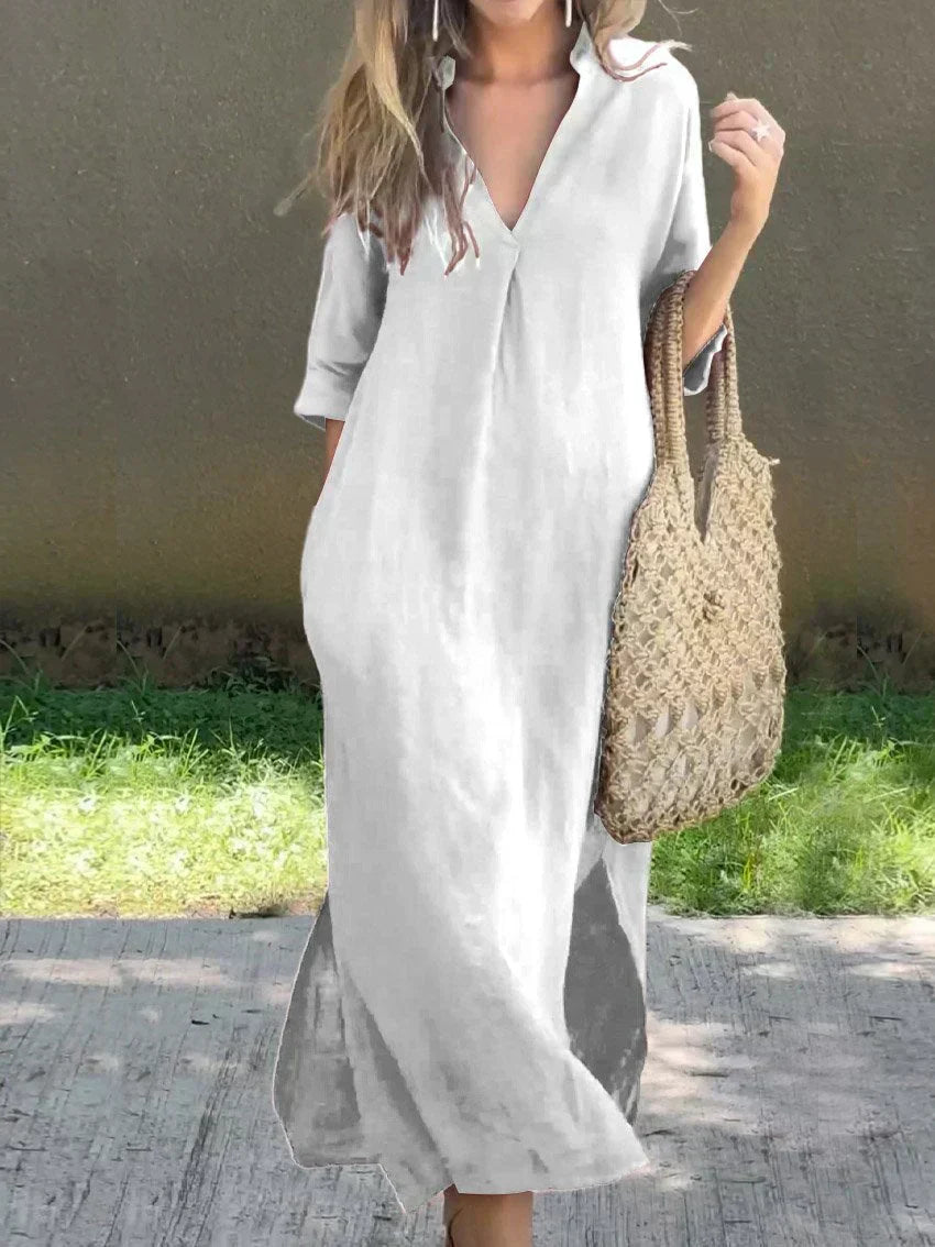 White casual shirt dress, V-neck, three-quarter sleeves, relaxed midi length with side slit