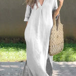 White casual shirt dress, V-neck, three-quarter sleeves, relaxed midi length with side slit