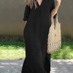 Black casual shirt dress, V-neck, three-quarter sleeves, relaxed midi length with side slit