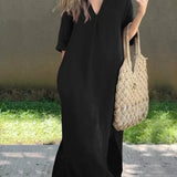 Black casual shirt dress, V-neck, three-quarter sleeves, relaxed midi length with side slit