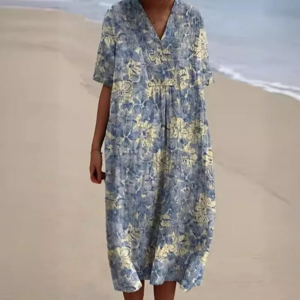 Light blue midi dress with V-neck and short sleeves, floral botanical print and gathered waist