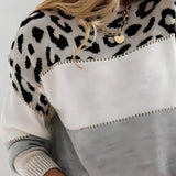 Leopard-print pullover sweater close-up, white front with black spots and gray hem