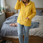 Yellow hooded rain jacket with long sleeves, zip front, and front pockets