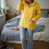 Yellow hooded rain jacket with long sleeves, zip front, and front pockets