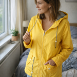 Yellow hooded rain jacket detail: zip front, drawstring hood, and pockets