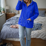 Blue hooded rain jacket with long sleeves, zip front, and front pockets