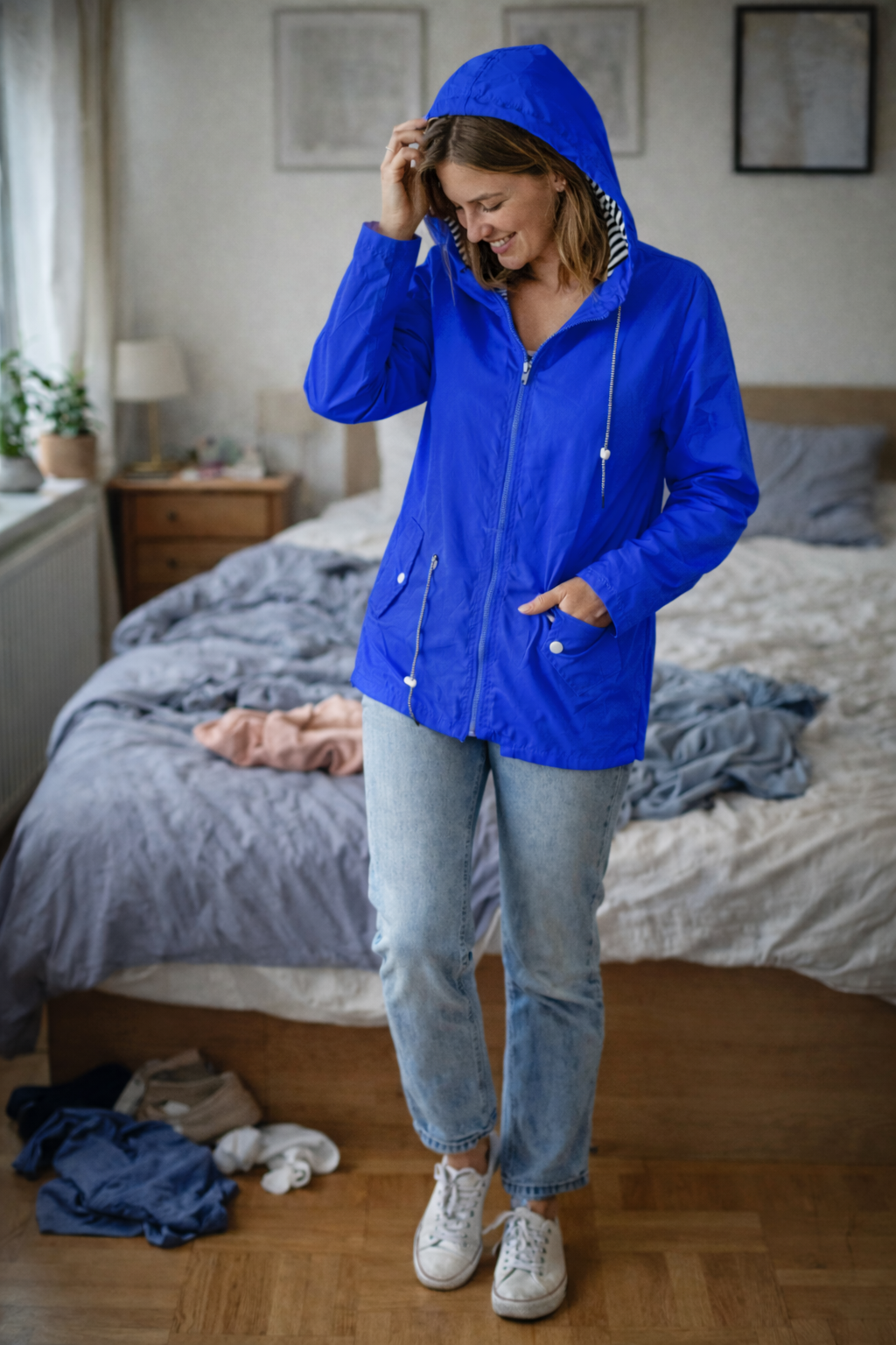 Blue hooded rain jacket with long sleeves, zip front, and front pockets