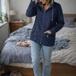 Navy hooded rain jacket with long sleeves, zip front, and front pockets