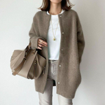 Oversized tan button-front knit cardigan with long sleeves and side pockets
