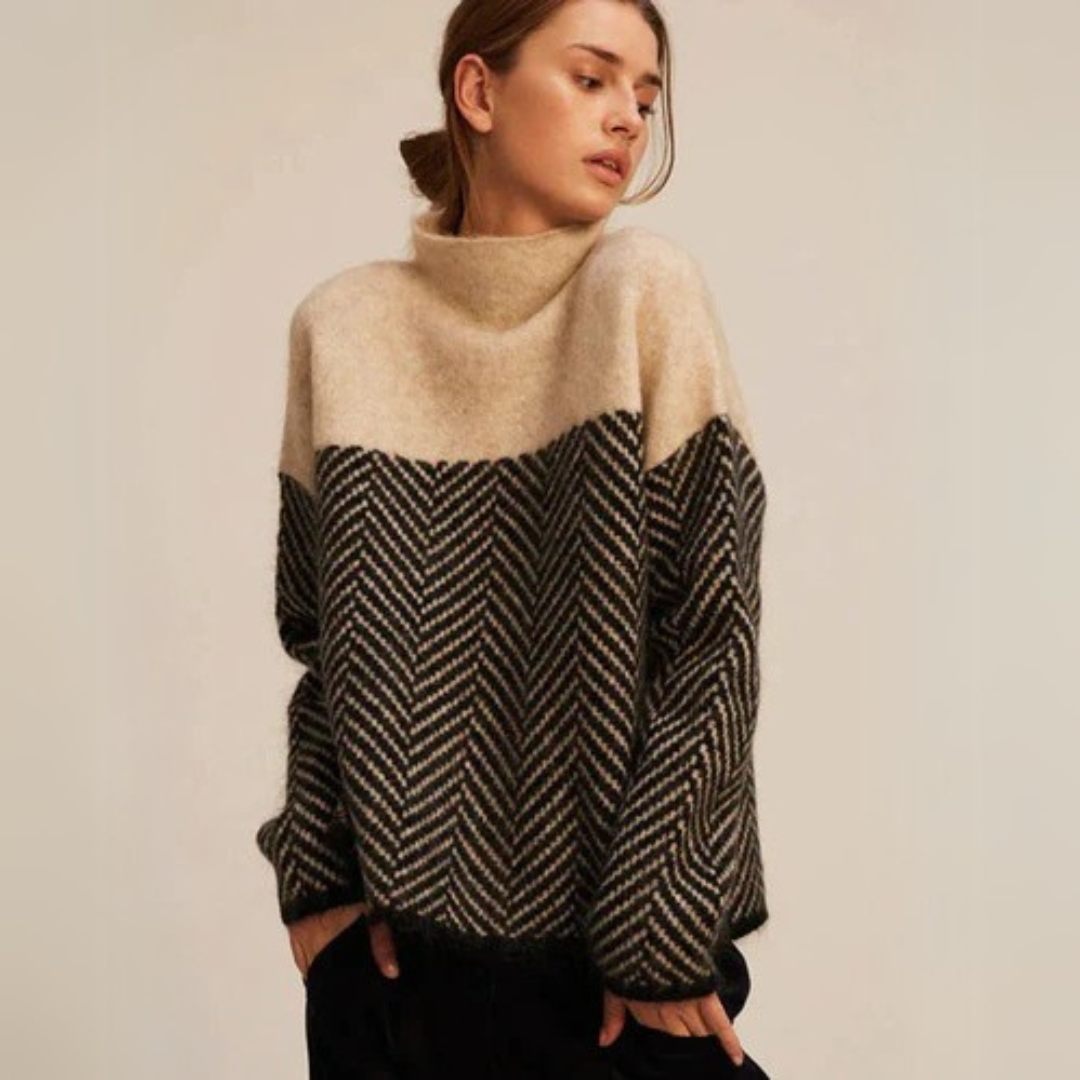 Beige turtleneck sweater with black-and-white chevron yoke and hem