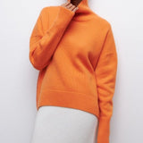 Orange turtleneck sweater with long sleeves and ribbed knit trim