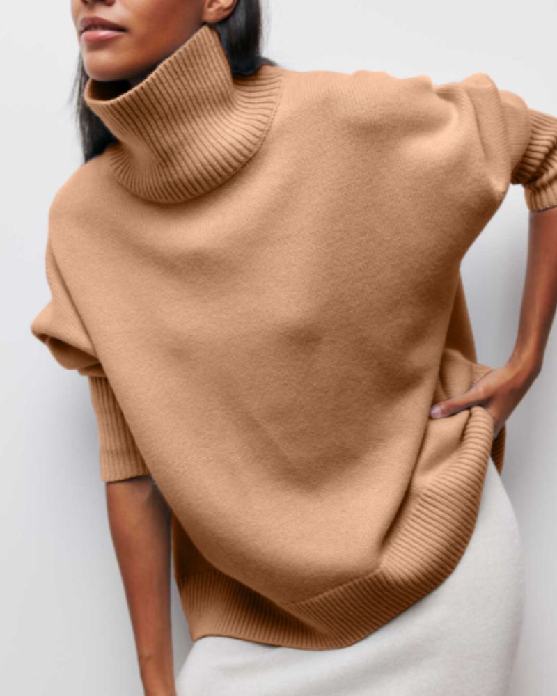 Tan turtleneck sweater with ribbed collar and hem detail at sleeves
