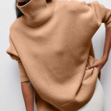 Tan turtleneck sweater with ribbed collar and hem detail at sleeves