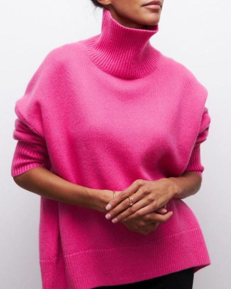 Pink turtleneck sweater with thick rib-knit collar and relaxed fit