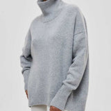 Heather gray turtleneck sweater with ribbed cuffs and high neckline