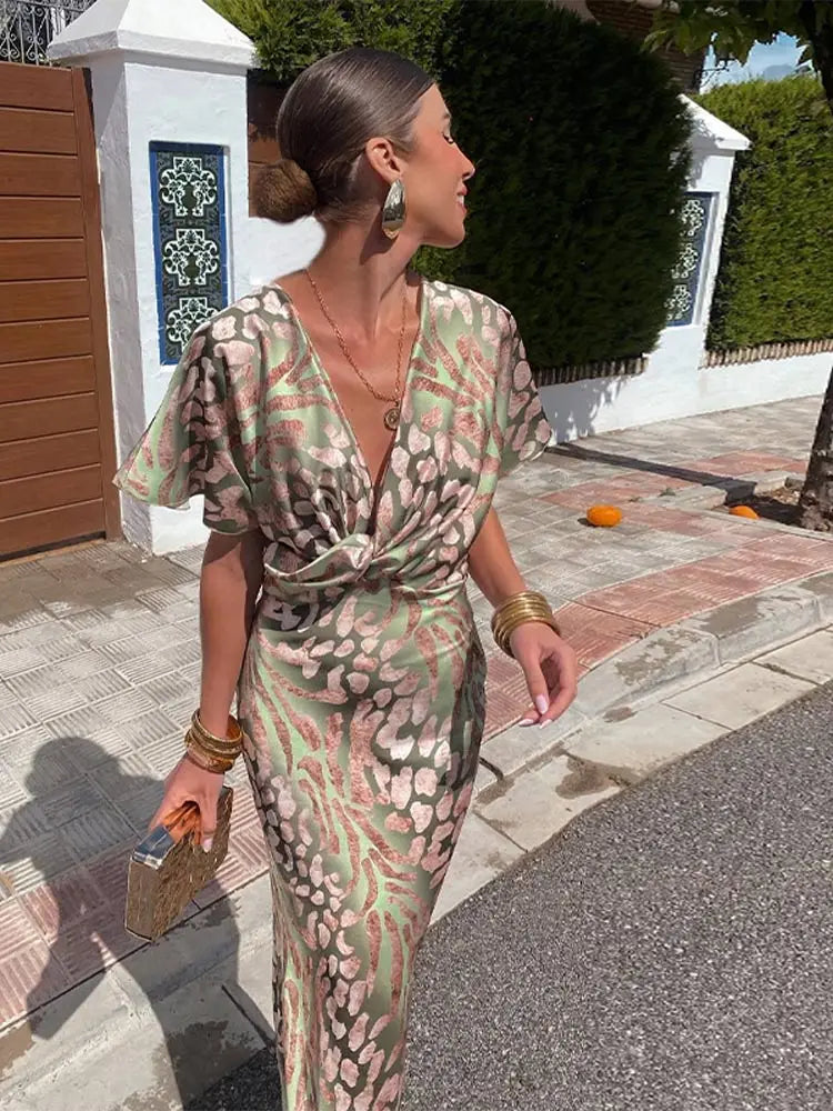 Midi wrap dress with V-neck and short flutter sleeves, light green and pink abstract print