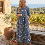 Navy midi dress with three-quarter sleeves and gold botanical print, gathered waist