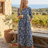 Navy midi dress with three-quarter sleeves and gold botanical print, gathered waist