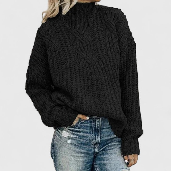 Black knit crewneck cable pullover with long sleeves and ribbed cuffs