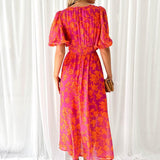 Pink-orange floral midi dress with puff sleeves and back tie detail, back view