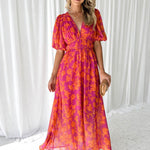 Pink-orange floral midi dress with puff sleeves and V-neck, flowing skirt