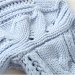 Light blue cable-knit pullover with high neck and textured stitch detail