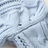 Light blue cable-knit pullover with high neck and textured stitch detail