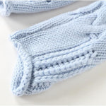 Light blue cable-knit pullover cuff and hem with ribbed edge