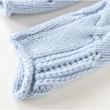 Light blue cable-knit pullover cuff and hem with ribbed edge