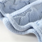 Light blue cable-knit pullover sleeve with textured knit and ribbed cuff