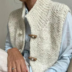 Cream textured sleeveless cardigan with five-button front and ribbed shawl collar